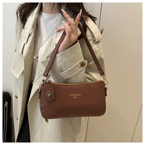 Detail of dark brown pebble leather handbag with gold zippers and Fashion Bag logo