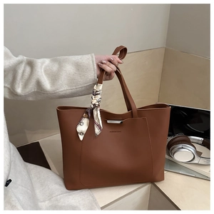 Brown tote bag detail with silk scarf and Fashion & Bag text in a lifestyle office setting