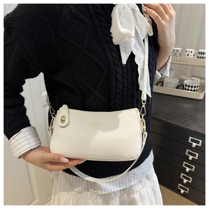 Detail of white litchi grain leather crossbody bag with golden Fashion Bag text