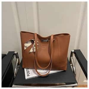 Close-up of caramel leather tote bag with silk scarf detail and Fashion & Bag text