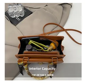 Interior view of vintage brown bag showing capacity for phone, sunglasses and cosmetics