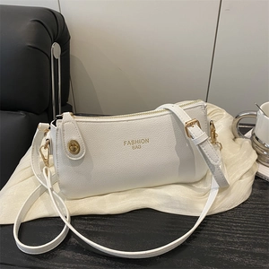 Elegant white textured leather crossbody bag with gold hardware and top handle strap