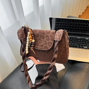 Chic leopard print crossbody square bag in brown faux suede with a beaded tassel strap