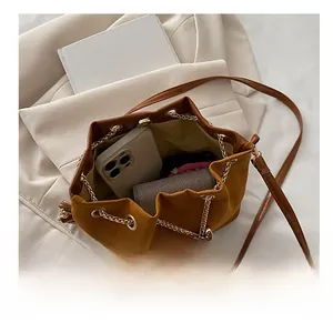 Top view of brown suede bucket bag interior showing capacity for phone and wallet