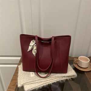 Chic burgundy leather tote bag with decorative silk scarf and fashion engraving