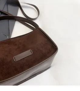 Detail of dark brown faux suede and leather texture on a large minimalist tote bag