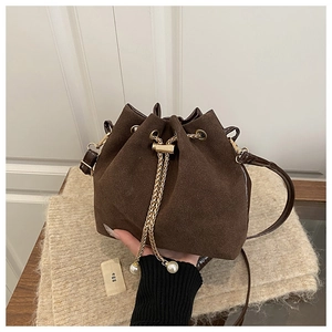 Detail of vintage brown bucket bag with gold chain drawstring and pearl charms