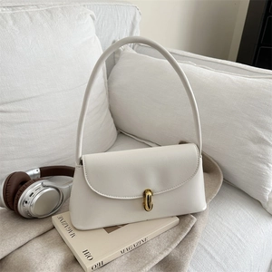 Minimalist creamy white leather underarm bag with elegant gold swivel buckle closure