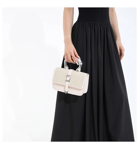 Detail of cream leather square bag with V-weave texture and U-shaped silver metal handle