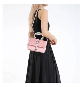 Pink woven square handbag with unique silver metal handle and heart-shaped buckle detail