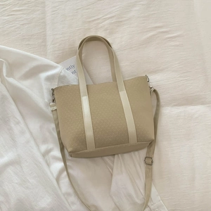 Close-up of vintage bucket bag featuring monogram canvas texture and belt strap detail