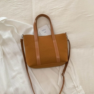 Detail of vintage brown bucket bag showing corduroy texture and adjustable leather strap