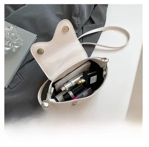 Interior view of small crossbody bag showing capacity for phone and cosmetics