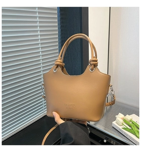 Detail of khaki leather handbag with wavy rim, knot handle and FASHION H.C BAG stamp