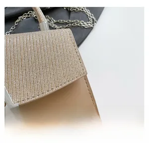 Detailed close-up of champagne glitter and beige leather stitching on a chain bag