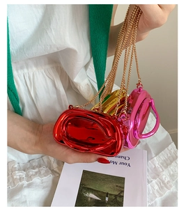 Mini metallic party bags in red, gold, and pink with sleek handles and gold chain straps