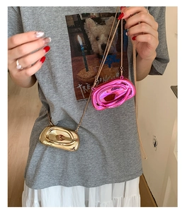Modern metallic oval clutch bags in gold and pink with fine chain straps