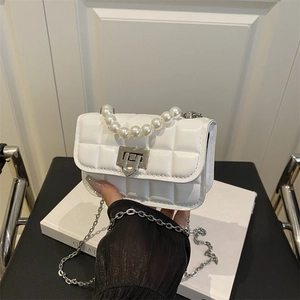 White quilted mini crossbody bag with pearl top handle and silver metal chain strap