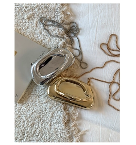 Detailed view of mini metallic chain bags in gold and silver with mirror finish