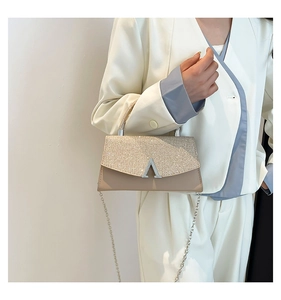 Detail of elegant V-shaped silver clasp on sparkling rhinestone evening handbag