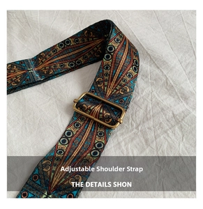 Macro view of adjustable woven strap with ethnic patterns and bronze metal buckle detail