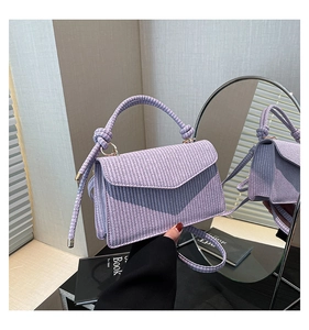 Detail of the lavender woven crossbody bag showing intricate cross-knit texture and rope handles