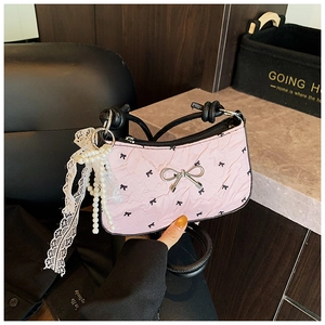 Pink pleated shoulder bag with black bow prints, pearl charms and lace detail