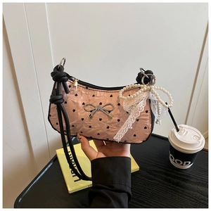 Pink heart-print handbag with a silver bow, lace ribbons, and pearl chain detail