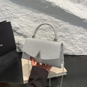 Silver glitter crossbody handbag with metal chain strap and minimalist V-shaped buckle
