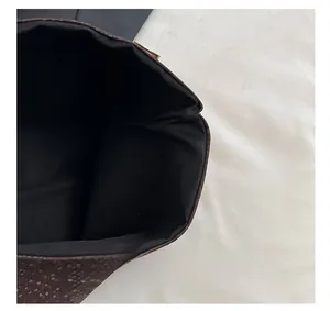 Detail show of snakeskin texture handbag with wide opening and black inner lining