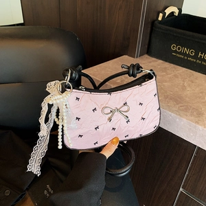 Pink pleated handbag with black bow prints and pearl lace ribbon accessories