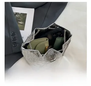 Silver woven bucket bag showing interior space for phone, wallet and cosmetics items
