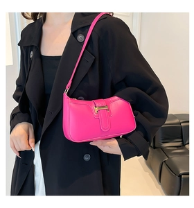 Detail of rose pink crescent shoulder bag with golden metallic buckle and smooth texture