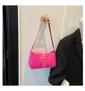 Detail of rose pink baguette bag with gold hardware buckle and smooth faux leather