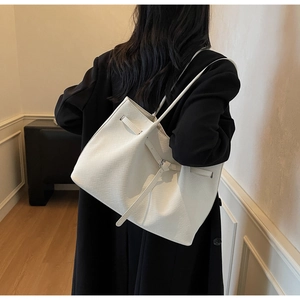 Detail of white woven leather tote bag showing fine texture and large capacity style