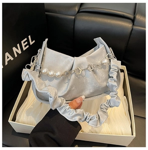 Détail du sac nuage argenté plissé avec chaîne en perles et fleurs dorées en coffret