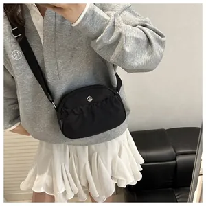 Detail of black nylon half-moon crossbody bag with ruffled pocket and M logo