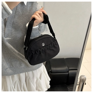 Detail of waterproof nylon crossbody bag with pleated front pocket and metal M logo