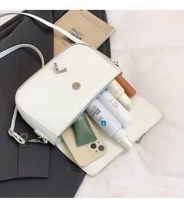 Internal view of a white half-moon saddle bag showing large capacity for essentials
