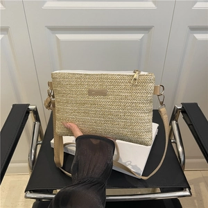 Beige woven crossbody bag with gold hardware and white zipper detail for women