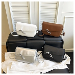Detail of square crossbody bags in white, brown, silver and black with pin decor