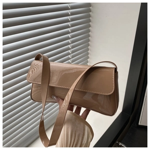 Détail du sac baguette en cuir verni kaki avec finition brillante et fermeture à rabat