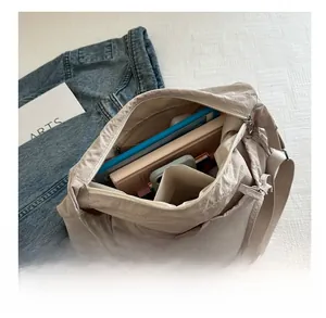 Spacious interior of a beige pleated nylon tote bag holding a tablet and daily essentials