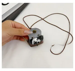 Detailed view of dark brown leather mini earphone case with lanyard and snap button closure