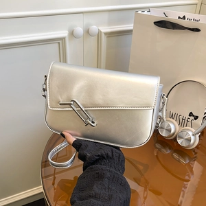 Silver metallic underarm bag with safety pin hardware and slim shoulder strap