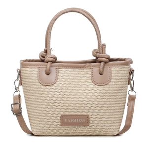 Pink straw bucket bag with leather handles and adjustable shoulder strap for summer commute