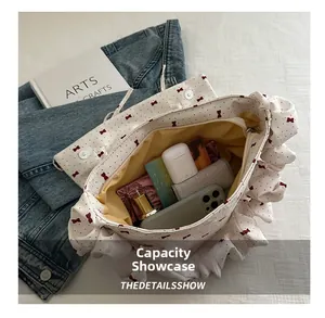 Interior capacity of the white bow-print canvas bag showing daily essentials