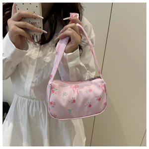 Close-up of pink floral shoulder bag with rose patterns and sweet ribbon prints