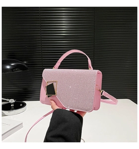 Detail of pink sequin flap and black geometric buckle on a stylish small square bag