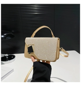 Detailed view of champagne gold sequined handbag with black gold geometric buckle